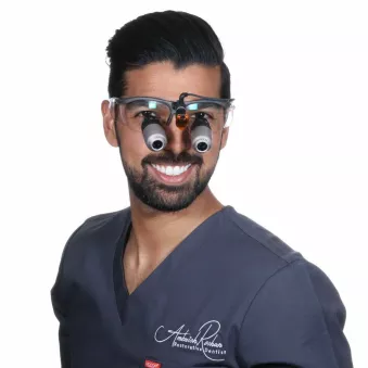 Dr. Ambrish Roshan wearing Orascoptic EyeZoom loupes.